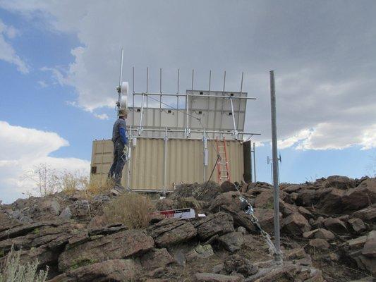 Our Technician adding Solar Panels to a new hilltop site.