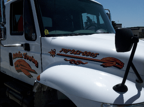 I created a logo and put it on a Large Tow Truck with three layers of vinyl