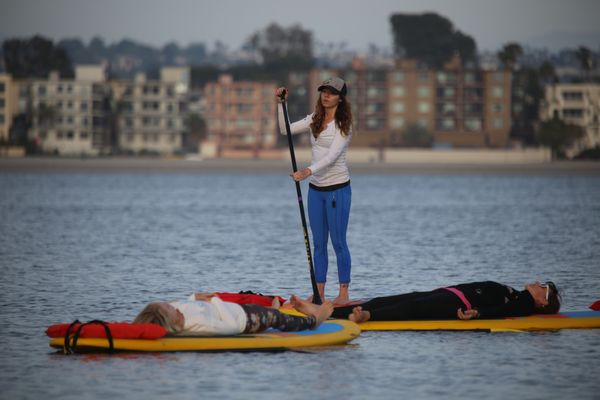 Melanie leading a SUP Yoga lesson during a 25 hour SUP Yoga teacher training in San Diego, CA.