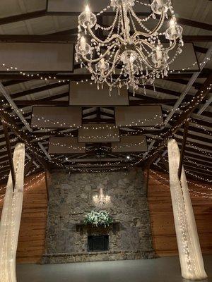 Fabric draping and chandeliers supplies by Kevin Griffin. Floral arrangement available for use at no extra charge.