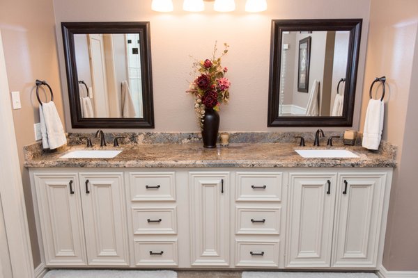 Complete bathroom remodel. New cabinets, counter tops, sinks, hardware, paint, and flooring.