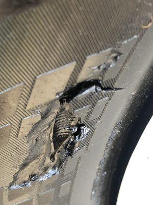 Illegal patched sidewall gash on the tire of the car this place sold...