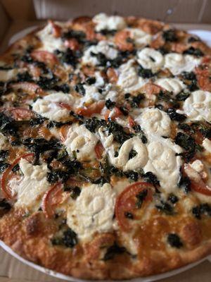 The Paul Castellano-Big Paulie (white pizza with ricotta, spinach, garlic, fresh tomatoes, mozzarella and cheddar)