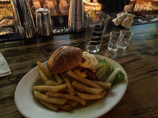 HANGOVER BURGER - Angus Beef burger with lettuce, onion & bacon, topped with a hard fried egg, served on a pan toasted brioche roll