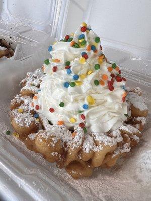 Birthday Cake Funnel Cake! Had icing melted into the warm crispy funnel cake, powder sugar, whipped cream and sprinkles!