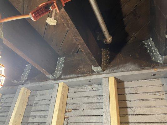 The new steel connectors holding the beams supporting the 1st floor to the load bearing wall.