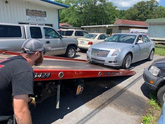 Towed with a winch, NOT driven on the ramp.