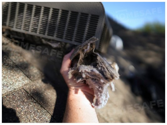 A chunk of dryer lint pulled out of a slant-back attic ventilation hood that had been installed as a rooftop dryer vent termination hood.