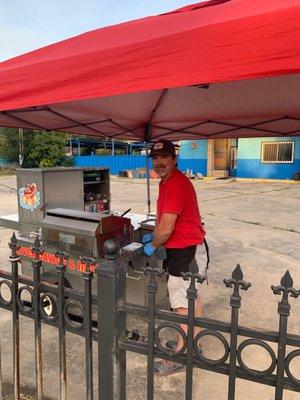 Happy man making hot dogs