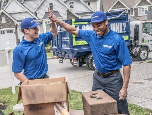 1-800-GOT-JUNK? Long Island East truck team members with boxes of junk