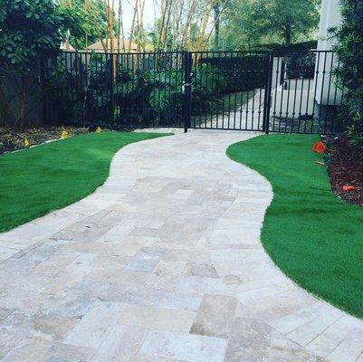 Travertine walkway with artificial turf installation