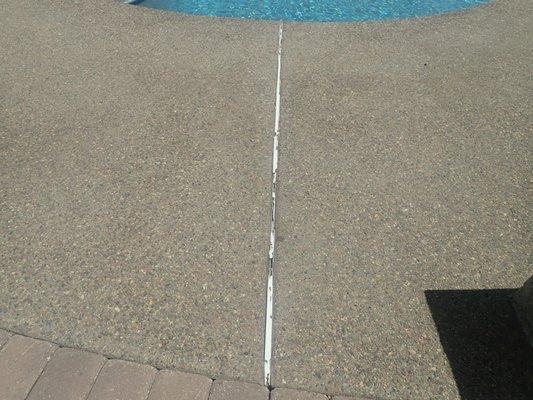 Damaged Plastic Spacer in a pool in Escondido. It can be replaced with Mastic!