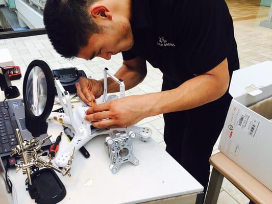 One of the Expert Drones repair techs working on a DJI Phantom 3 repair.