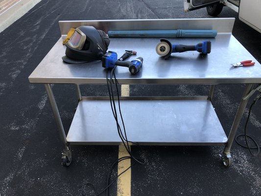 Repairing a stainless steel prep table for pizza restaurant.