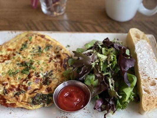 Frittata with kale , mushrooms, Parmesan and mozzarella cheese with field greens