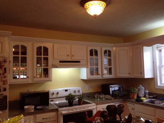 This kitchen and dining room was recently changed from light green to much brighter soft yellow in a local home in Charlestown .