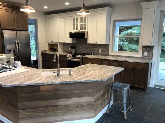 Kitchen in a newly built home.  Leather style counters with unique cedar tongue and groove