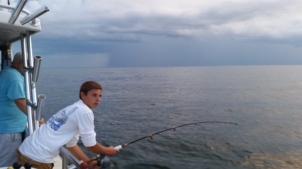 Young angler catching his 1st fish