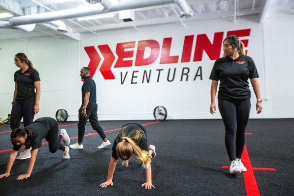 Experienced coaches help young athletes train for youth sports on the main floor of Redline Athletics Ventura