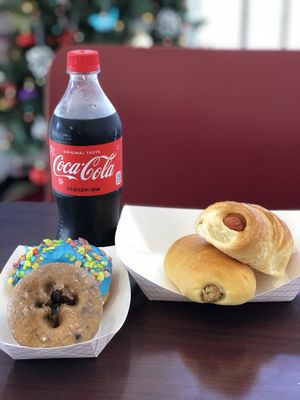 Large sausage a cheese croissant, Boudin, blueberry cake, fruity pebbles blue donut, and a coke!