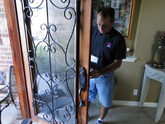 Locksmith working on door lock