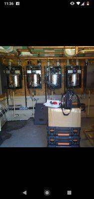 Technician work next four out of six compact boilers for hot water at apartment complex call Perry at area code 817-420-4609