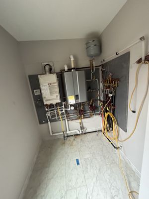 Tankless wall hung hot water heater and boiler installation.