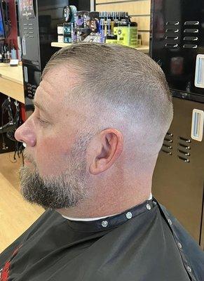 Bald fade using Super shaver with finger length on top using shears. Beard faded in.