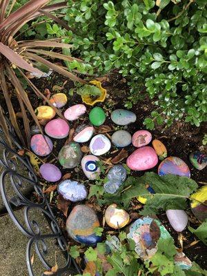 Garden featuring rocks painted by early learning students.