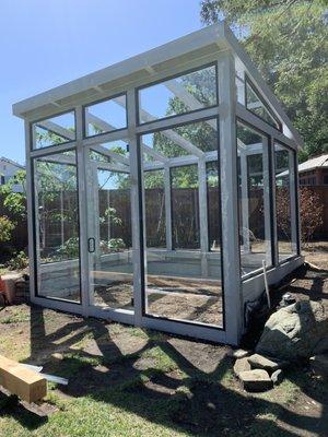 Aluminum framed glass enclosure in greenhouse