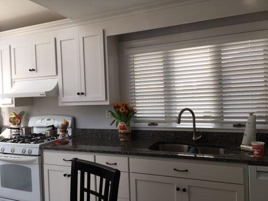 New doors and new drawers -- and a bright white -- make our granite countertops stand out.