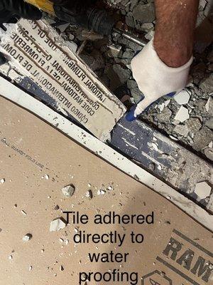 Tile adhered directly to waterproofing