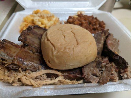 Mac and cheese, ribs, pulled pork, brisket, and baked beans with a roll