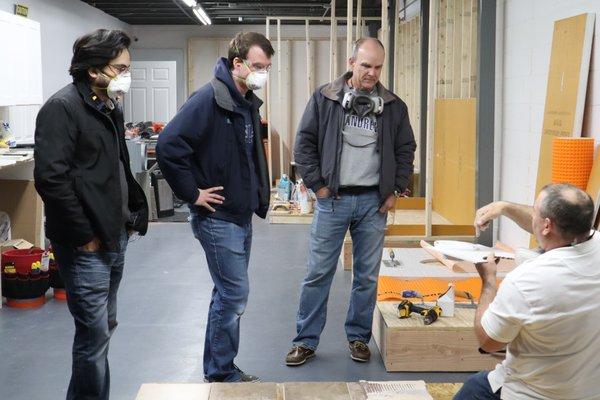 Workshop:  Learning how to install tile around a toilet flange.