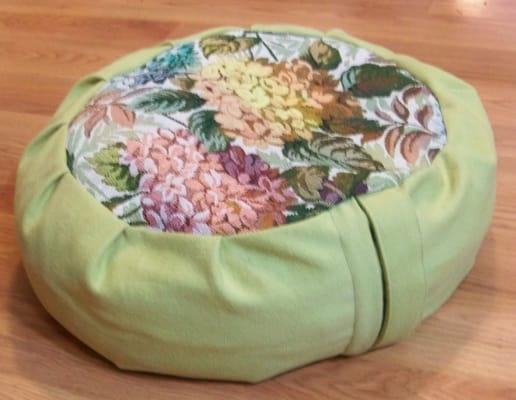 Green Floral Brocade Zafu filled with organic buckwheat hulls.  17 in x 6 in high.