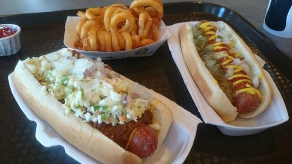 One with mustard, ketchup, onion & relish, one with mustard, chili, slaw & onion, and curly fries. Ball Park franks.