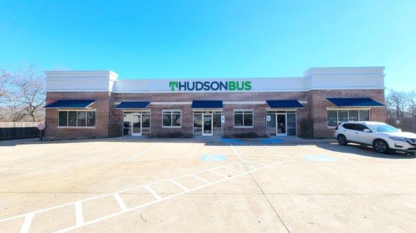 Hudson Bus Sale's Lewisville location from the road.