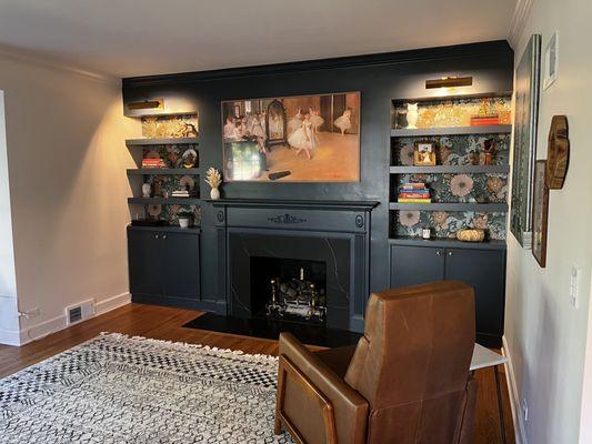 Custom floating shelves and cabinets with original fireplace mantle and new quartz surround.