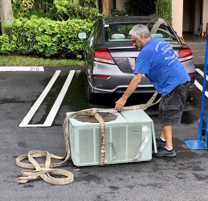 Xavier removing old Rheem Compressor from roof!