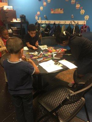 Kids working in small group on an art project.