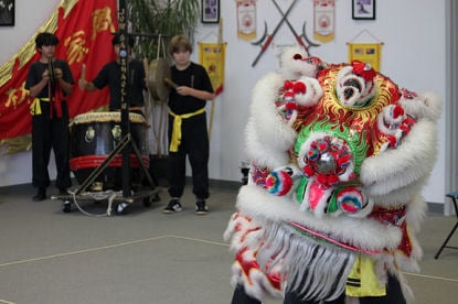 Kids have fun learning lion dance.