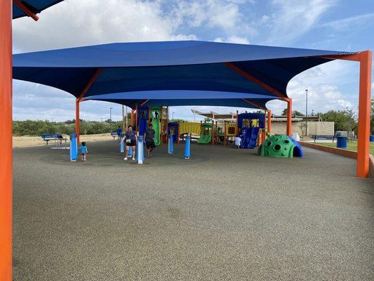 Large open play area under the shade.