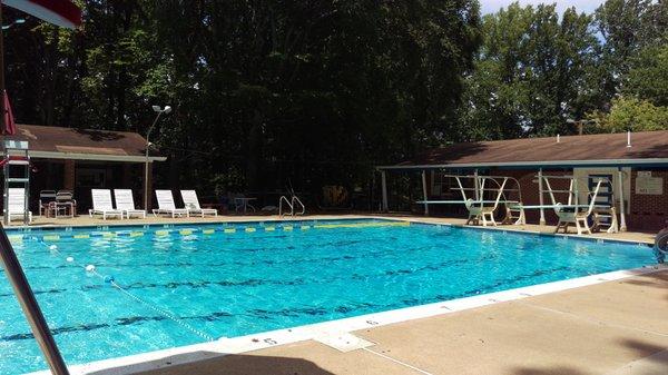 View of the diving boards in the deep pool, with the poolhouse in the background.