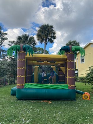 Back with bouncy house and basketball hoop to the right.