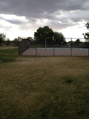 Large grass field two play areas a basketball court and a tennis court (but no nets)