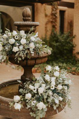 Flowers on the fountain outside before she moved them indoors