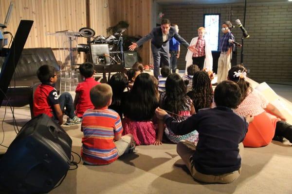 Pastor Angel tells a story for the children.