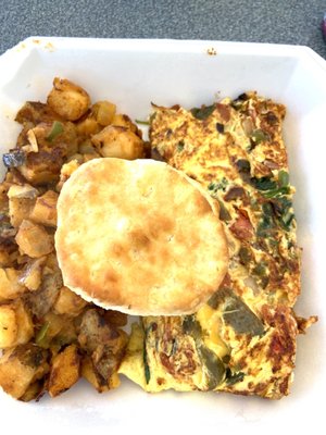 Omelette with smothered potatoes and a biscuit