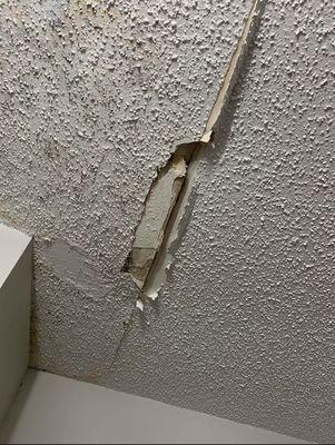 This is damage caused by this company's contractors in an attempt to "fix" my ceiling for other an upstairs leak and mold