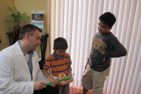 Dr. Beisel educating kids about the importance of brushing and dental decay.